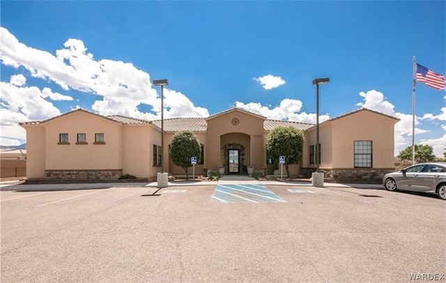 view of building exterior with uncovered parking