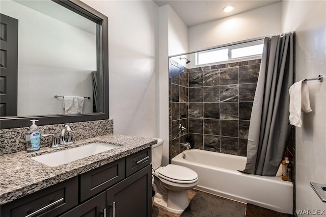 full bath with toilet, shower / bath combo with shower curtain, and vanity