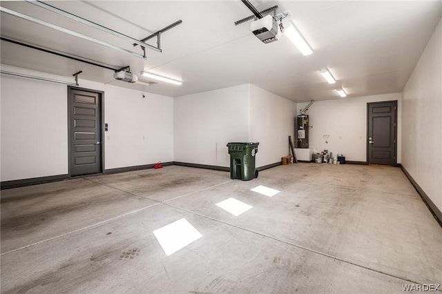 garage with baseboards, water heater, and a garage door opener