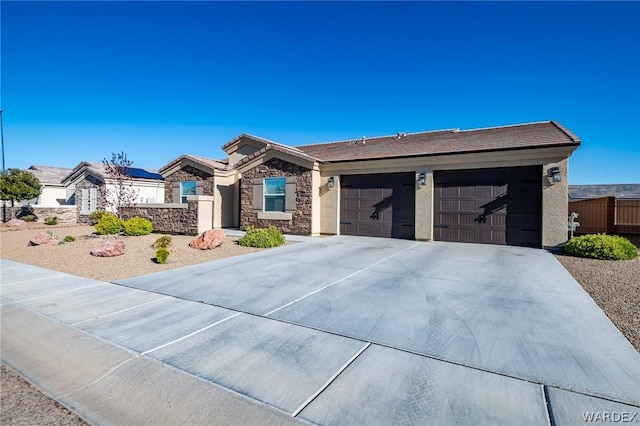 ranch-style house with a garage, concrete driveway, and stucco siding