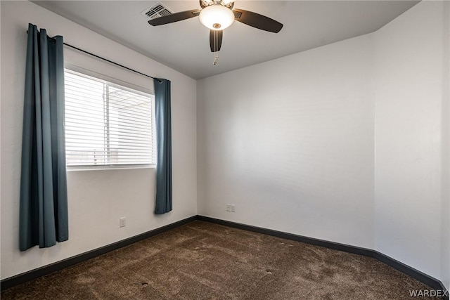 unfurnished room with visible vents, dark carpet, baseboards, and ceiling fan