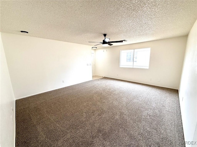 carpeted empty room with ceiling fan and a textured ceiling