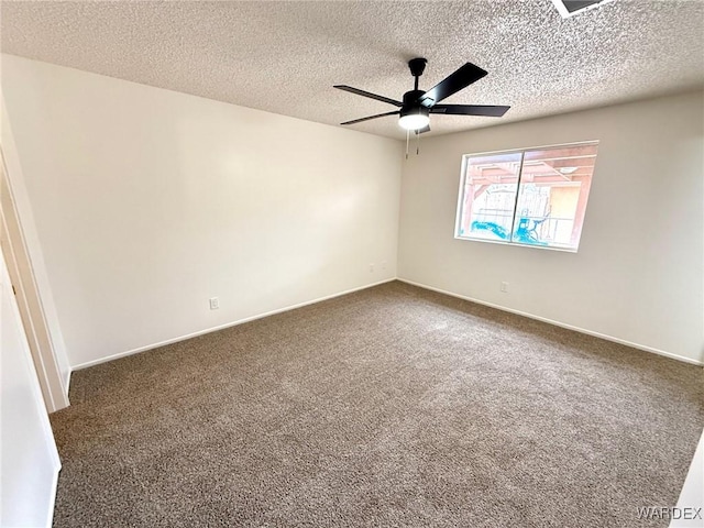 carpeted spare room with ceiling fan, a textured ceiling, and baseboards