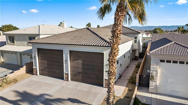 10726 S River Terrace Dr, Mohave Valley, AZ 86440 - mediterranean / spanish home featuring a tile roof, stucco siding, stone siding, and a mountain view