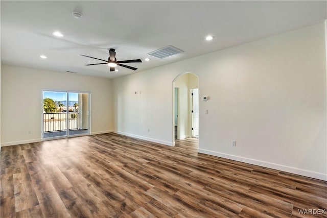 10726 S River Terrace Dr, Mohave Valley, AZ 86440 - unfurnished room with arched walkways, dark wood-type flooring, a ceiling fan, recessed lighting, and baseboards