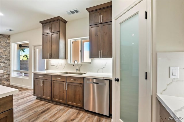 10726 S River Terrace Dr, Mohave Valley, AZ 86440 - kitchen with a sink, stainless steel dishwasher, light wood-type flooring, light countertops, and dark brown cabinetry