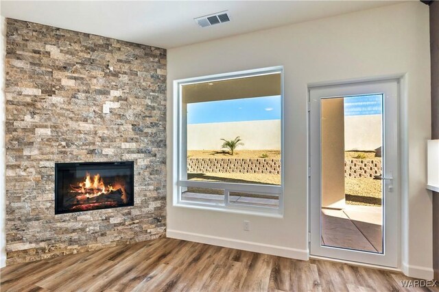 10726 S River Terrace Dr, Mohave Valley, AZ 86440 - doorway with wood finished floors and a stone fireplace