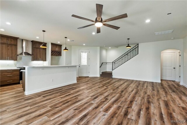 10726 S River Terrace Dr, Mohave Valley, AZ 86440 - unfurnished living room with wood finished floors, recessed lighting, a ceiling fan, baseboards, and stairs