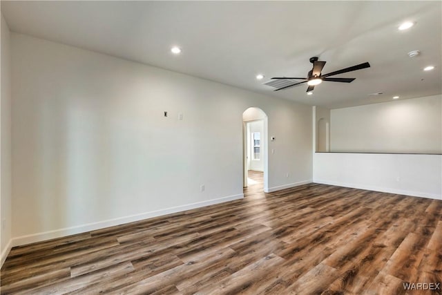 10726 S River Terrace Dr, Mohave Valley, AZ 86440 - unfurnished room with arched walkways, ceiling fan, recessed lighting, dark wood finished floors, and baseboards