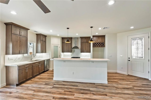 10726 S River Terrace Dr, Mohave Valley, AZ 86440 - kitchen featuring stainless steel dishwasher, wall chimney range hood, recessed lighting, and light wood-style flooring