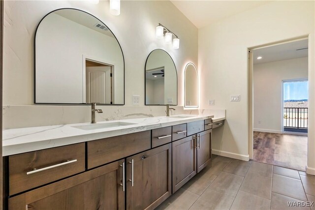 10726 S River Terrace Dr, Mohave Valley, AZ 86440 - full bath featuring double vanity, tile patterned flooring, and baseboards