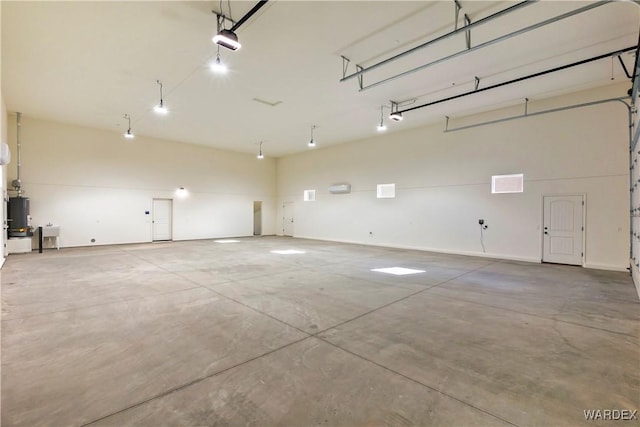10726 S River Terrace Dr, Mohave Valley, AZ 86440 - garage featuring a garage door opener and water heater
