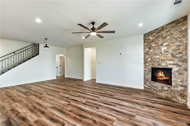 10726 S River Terrace Dr, Mohave Valley, AZ 86440 - unfurnished living room with wood finished floors, ceiling fan, recessed lighting, arched walkways, and a fireplace