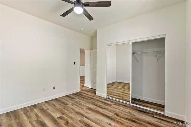 10726 S River Terrace Dr, Mohave Valley, AZ 86440 - unfurnished bedroom featuring wood finished floors, a closet, baseboards, and a ceiling fan