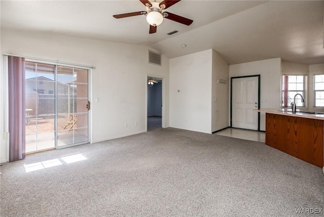 interior space with visible vents, a sink, and light colored carpet