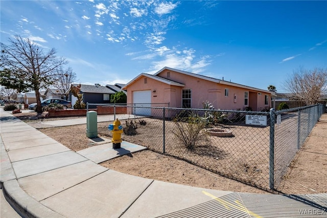 view of front facade featuring a fenced front yard and stucco siding