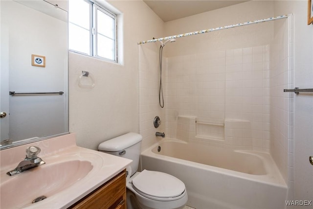 bathroom featuring toilet, shower / washtub combination, and vanity