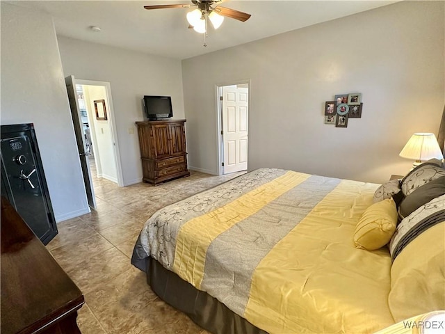 tiled bedroom with a ceiling fan and baseboards
