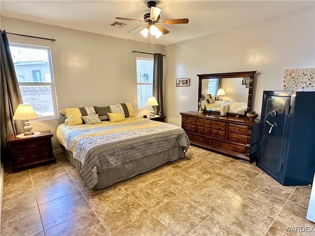 bedroom with light tile patterned floors, a ceiling fan, and visible vents