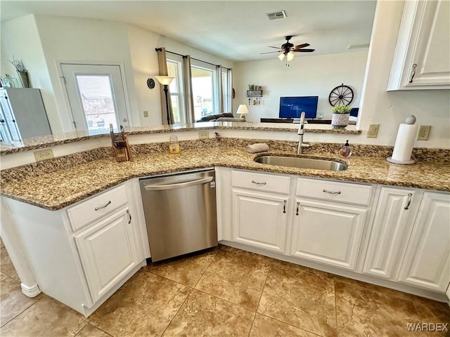 kitchen featuring light stone counters, a sink, visible vents, dishwasher, and a ceiling fan