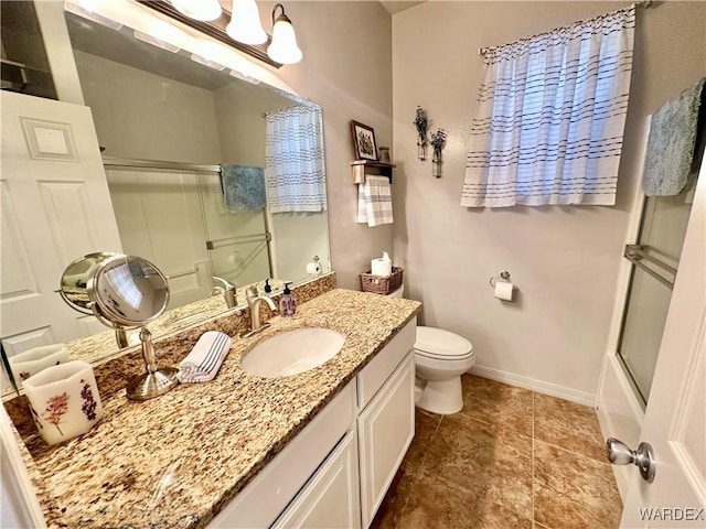 full bathroom featuring vanity, tile patterned floors, toilet, baseboards, and a shower with door
