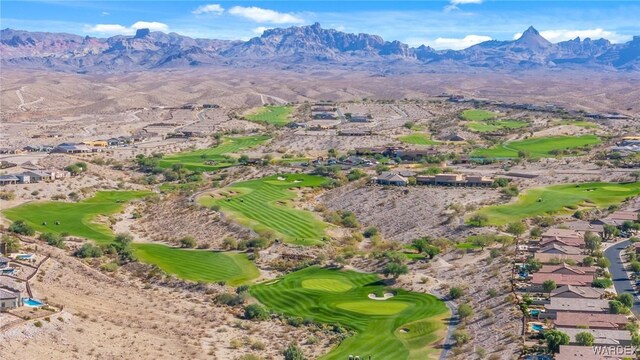 drone / aerial view with a residential view, a mountain view, and golf course view