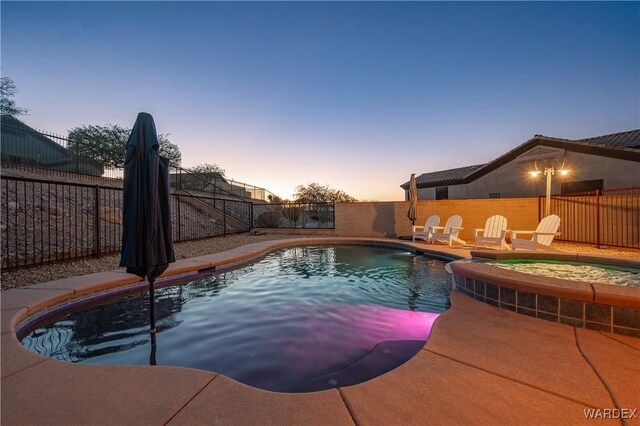 view of swimming pool featuring an in ground hot tub, a patio area, a fenced backyard, and a fenced in pool