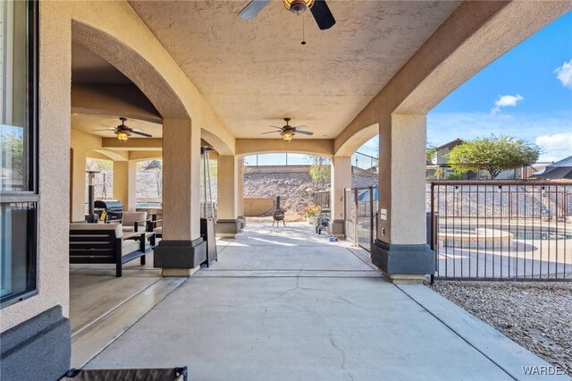 view of patio / terrace featuring fence, an outdoor living space, and ceiling fan