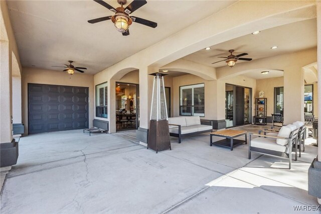 view of patio / terrace with a garage and an outdoor hangout area