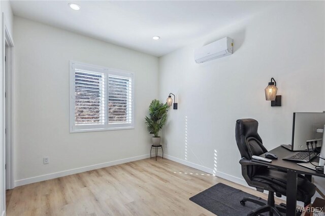 office area with recessed lighting, an AC wall unit, baseboards, and light wood finished floors