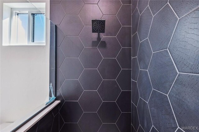 interior details featuring a tile shower