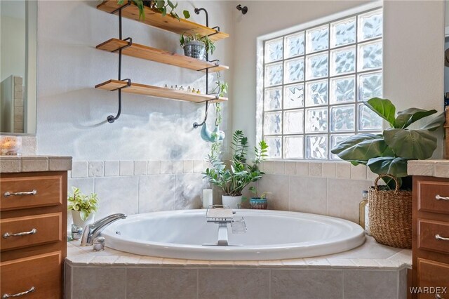 full bathroom featuring a bath and vanity