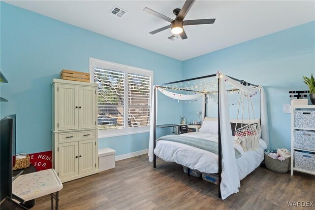 bedroom featuring baseboards, visible vents, ceiling fan, and dark wood-type flooring