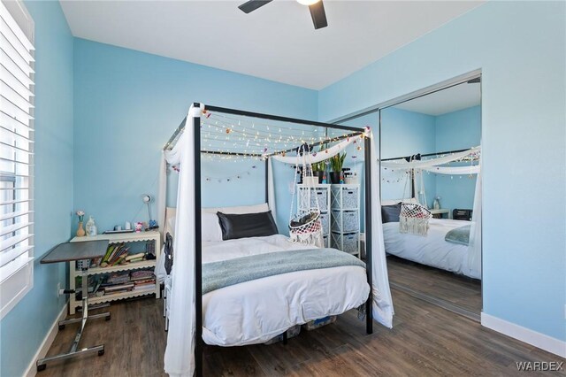 bedroom with ceiling fan, baseboards, and dark wood-style flooring