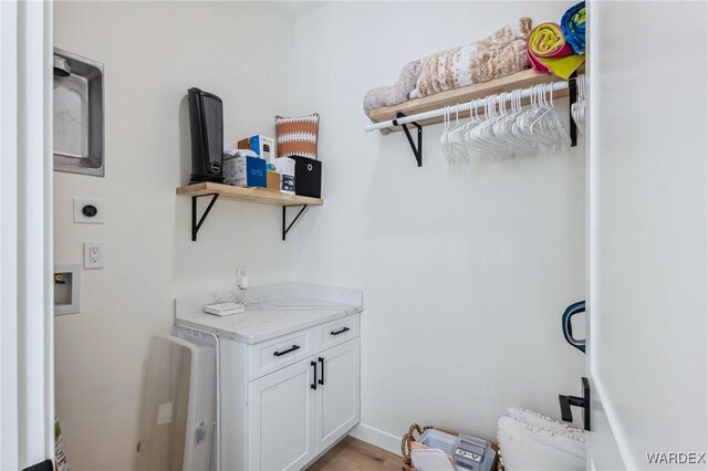 laundry area with cabinet space and hookup for an electric dryer