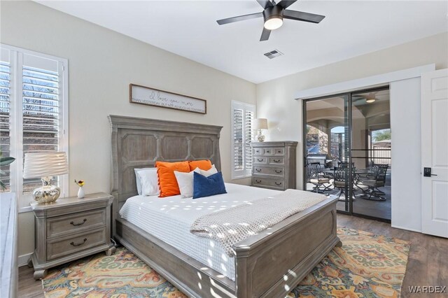 bedroom featuring access to outside, wood finished floors, visible vents, and a ceiling fan