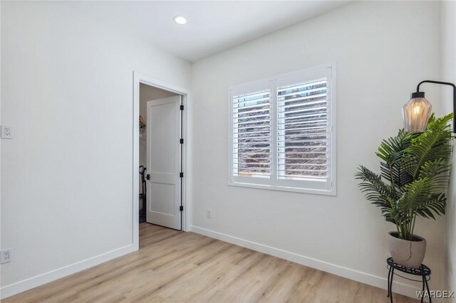 spare room with light wood-style flooring, baseboards, and recessed lighting