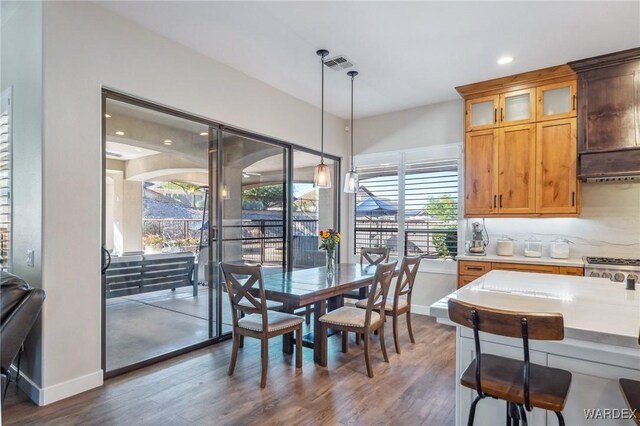 dining room featuring baseboards, visible vents, and dark wood-type flooring