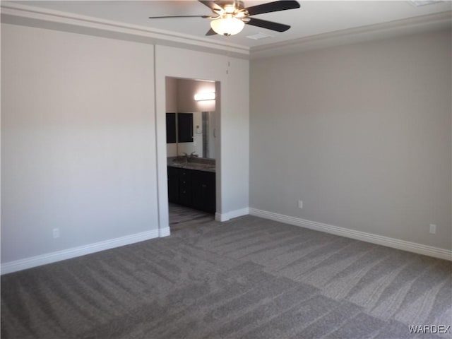 empty room with carpet floors, baseboards, and a ceiling fan