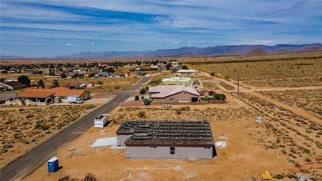 birds eye view of property with a mountain view and view of desert