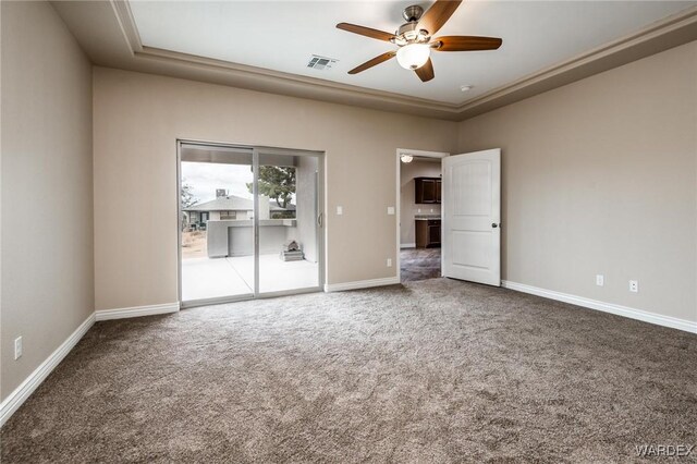unfurnished room with carpet, visible vents, baseboards, and ceiling fan