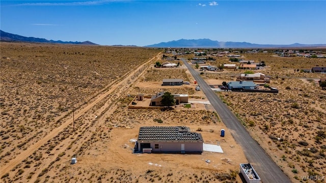 birds eye view of property with a rural view, a mountain view, and view of desert