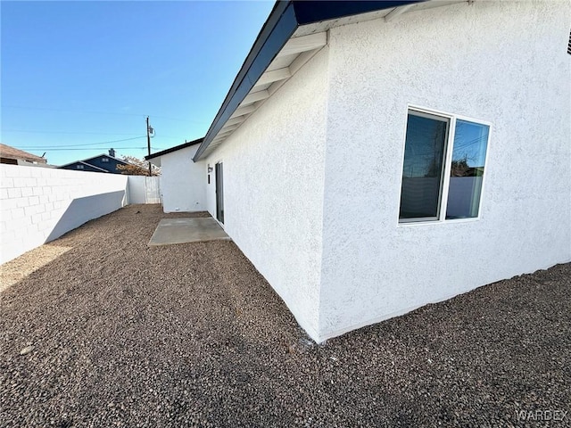 view of property exterior featuring a fenced backyard and stucco siding