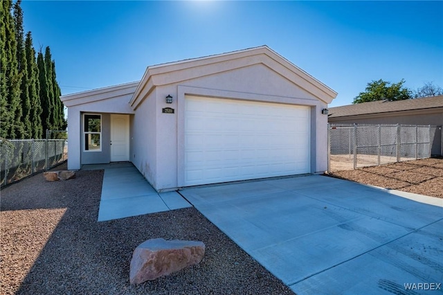 view of front of home with a garage, fence, driveway, and stucco siding