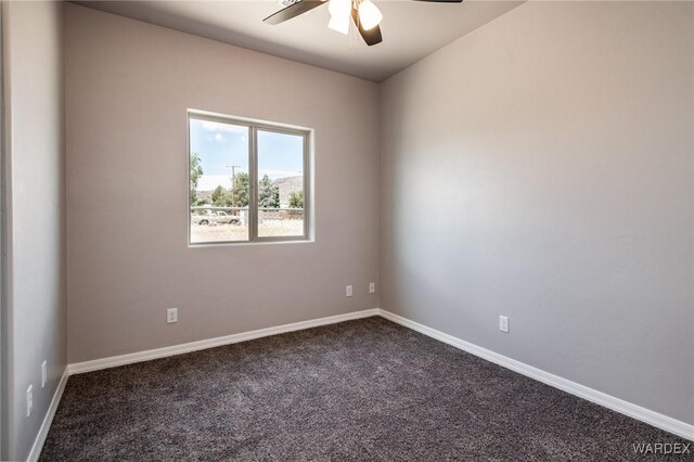 spare room with ceiling fan, carpet flooring, and baseboards