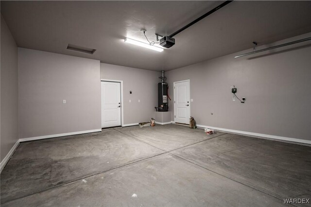 garage featuring a garage door opener, water heater, and baseboards