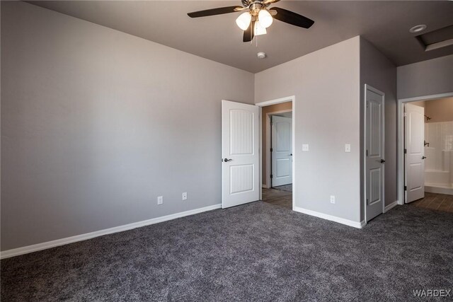 unfurnished bedroom featuring baseboards, dark carpet, and ceiling fan