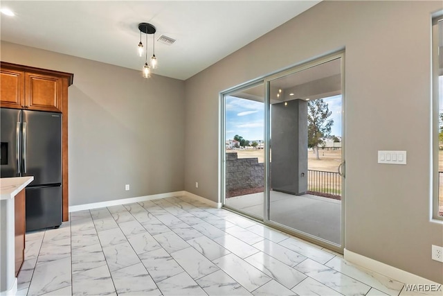 unfurnished dining area with marble finish floor, visible vents, and baseboards