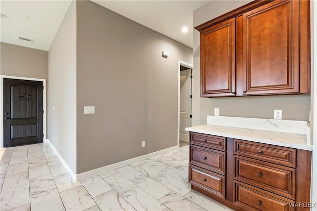 kitchen with marble finish floor, recessed lighting, and baseboards