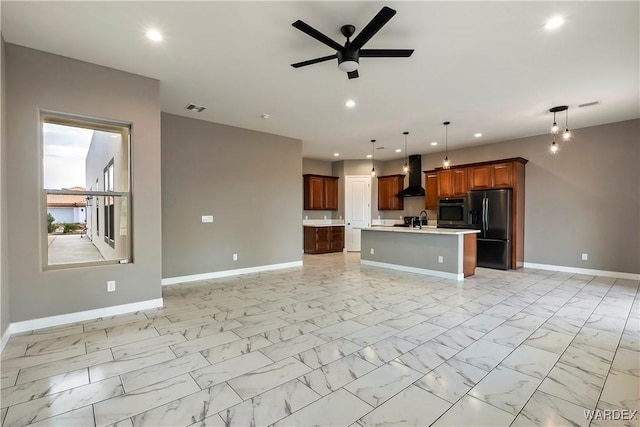 kitchen with black fridge with ice dispenser, stainless steel oven, light countertops, wall chimney exhaust hood, and decorative light fixtures